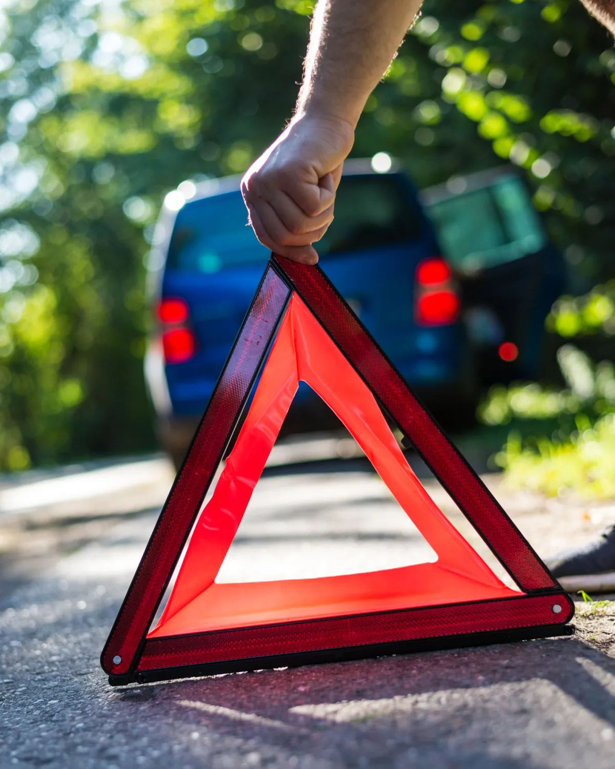 Placing a warning triangle beside a broken-down car
