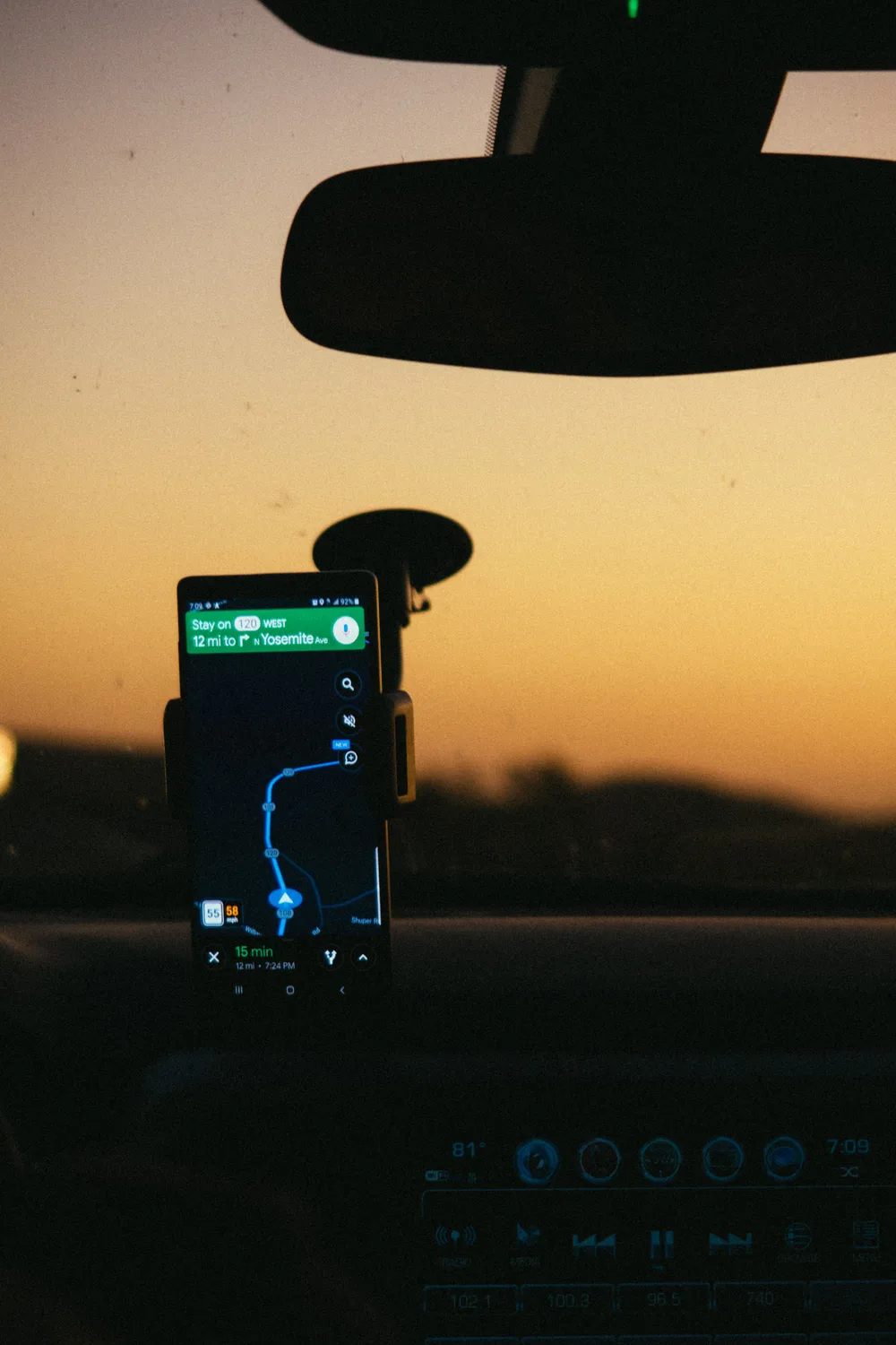 Phone showing turn-by-turn route navigation in a car